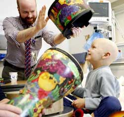 Music Therapist Brian Schreck leads a music therapy session with a patient. 